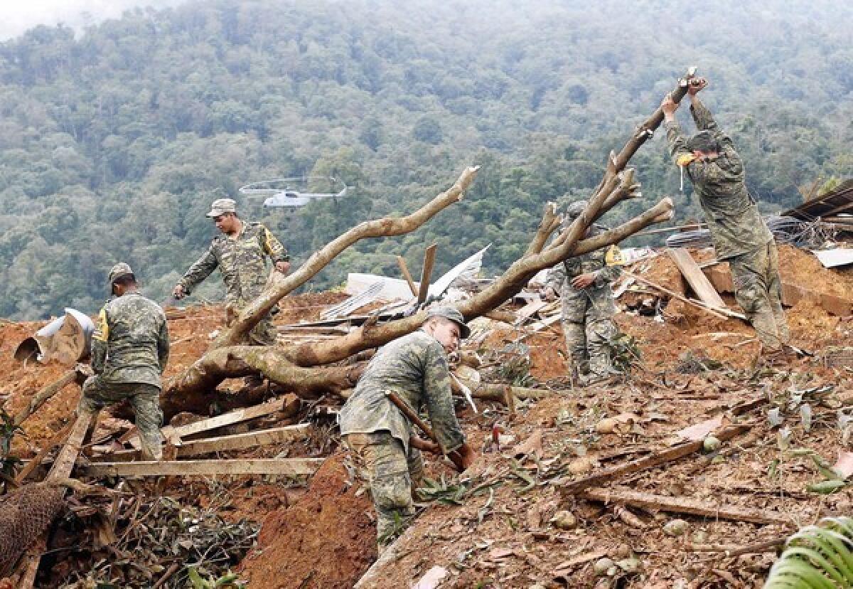 Mexican soldiers work in La Pintada after a rain-driven mudslide swept away residents and homes.