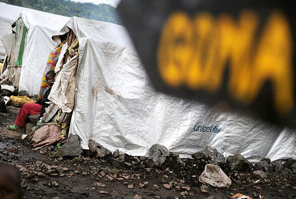 A boy sits in front of a temporary shelter where he and his family live in a camp for internally displaced people in Kibati, just north of the provincial capital city of Goma in eastern Congo. Hundreds of thousands of people living in the region have been displaced from their homes because of armed clashes in the region. The Kibati camp houses some 60, 000 refugees.