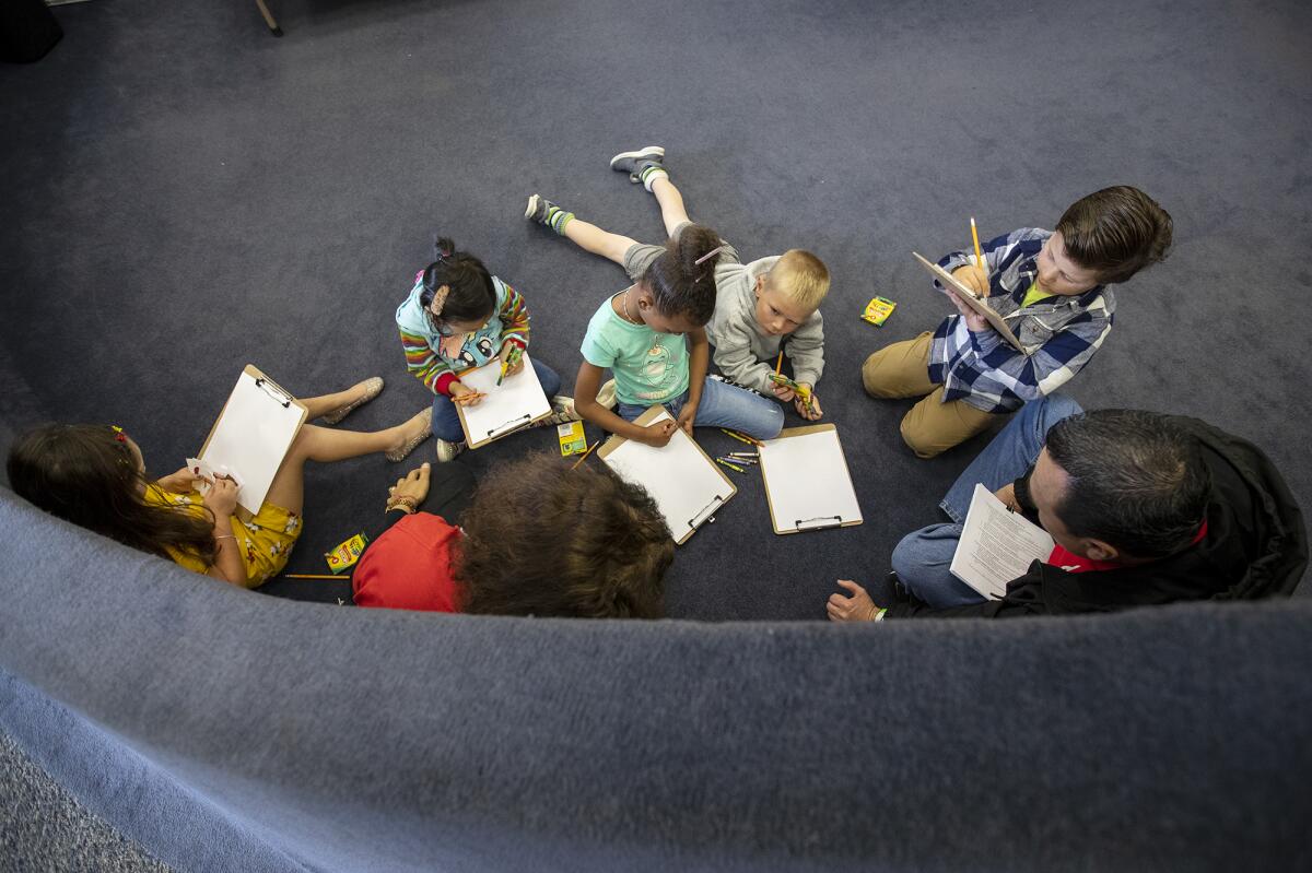 Volunteers read to kindergarten students at Golden View Elementary.