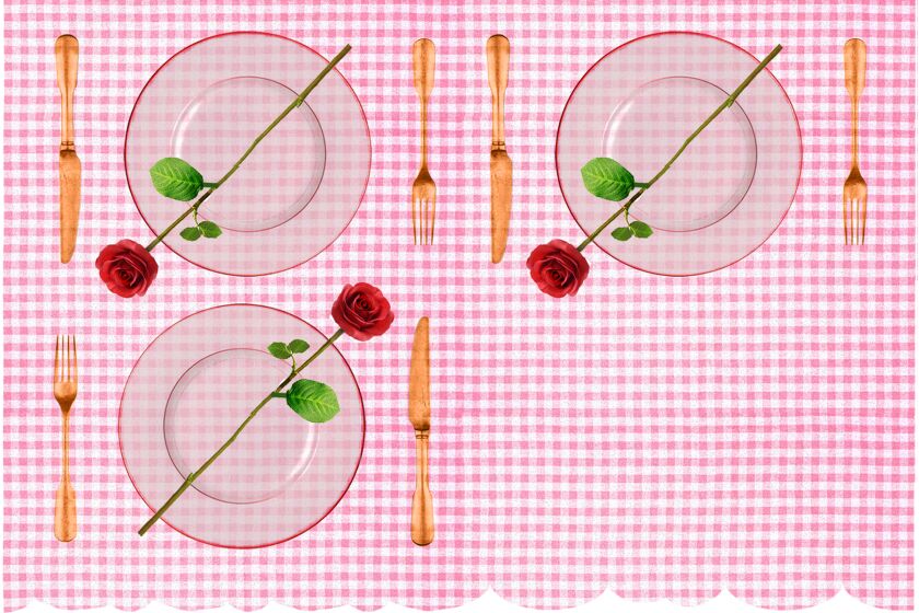 Place settings for three people with a rose atop each plate.