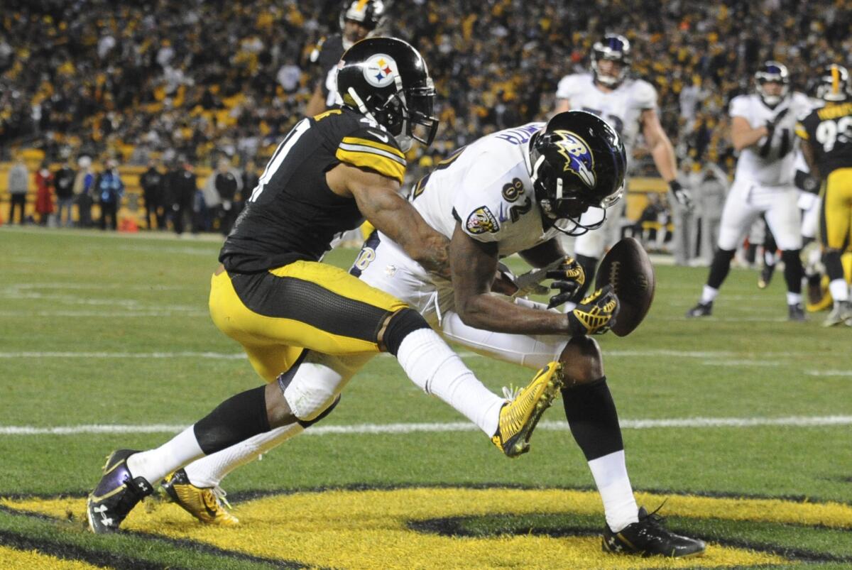 Baltimore Ravens wide receiver Torrey Smith (82) can't make a catch as Pittsburgh Steelers defensive back Antwon Blake (41) defends in the fourth quarter of an NFL football game on Sunday in Pittsburgh.