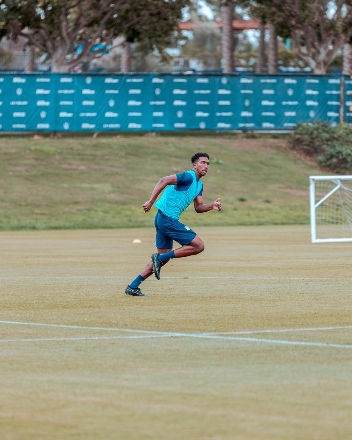 Kobi Henry sprints on the field during an Orange County SC training session.