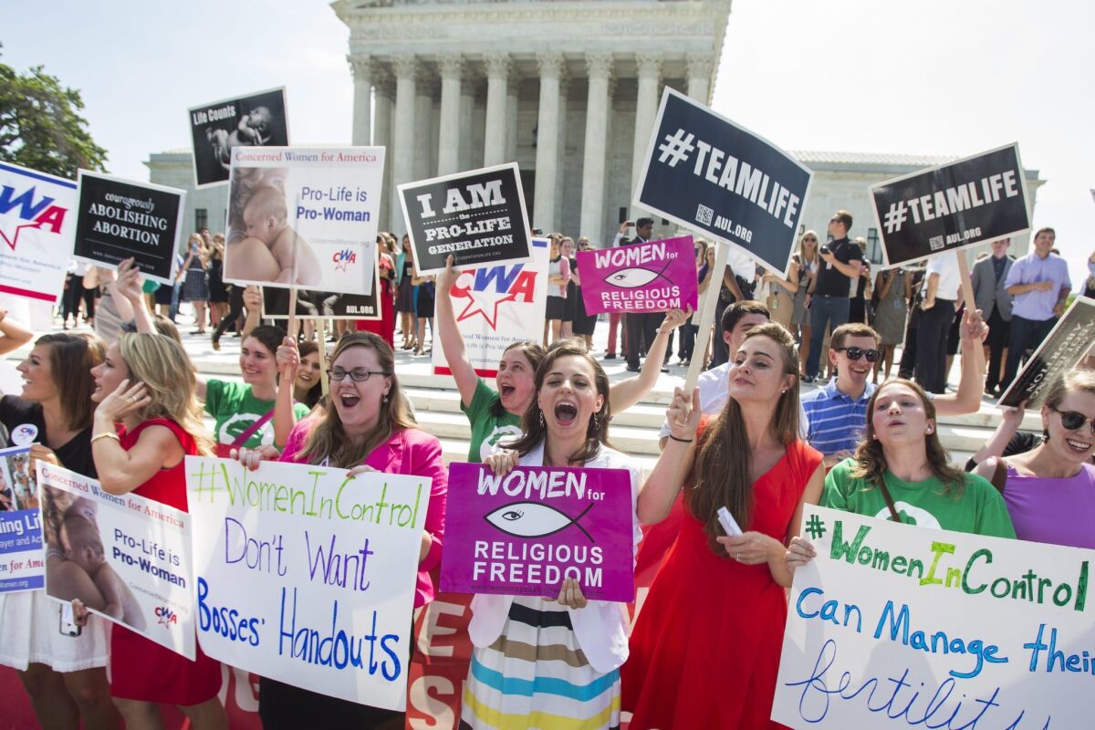 Supporters cheer the 5-4 ruling by the U.S. Supreme Court in favor of Hobby Lobby, the craft store chain that challenged the Affordable Care Act's mandate that employee health plans include contraceptive coverage.