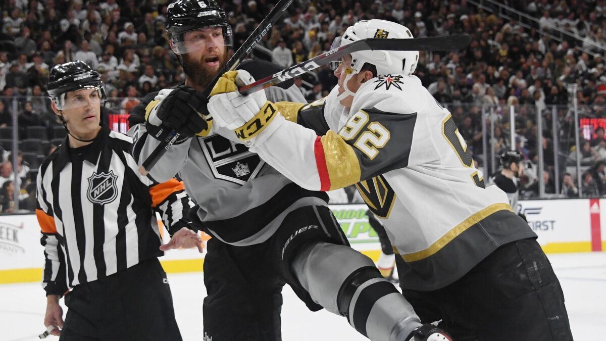 Vegas Golden Knights' Tomas Nosek, right, shoves Kings' Jake Muzzin in the second period on Dec. 23, 2018 in Las Vegas.