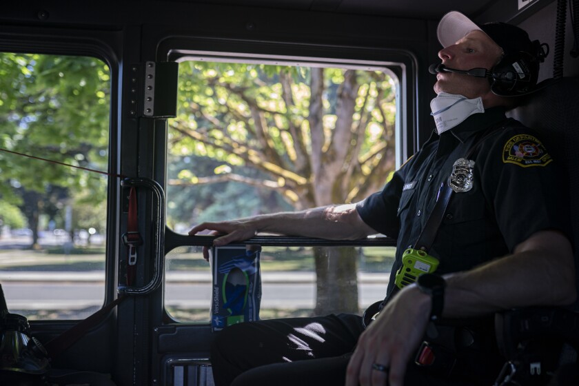 Paramedic Justin Jones tries to stay cool after responding to a heat exposure call 