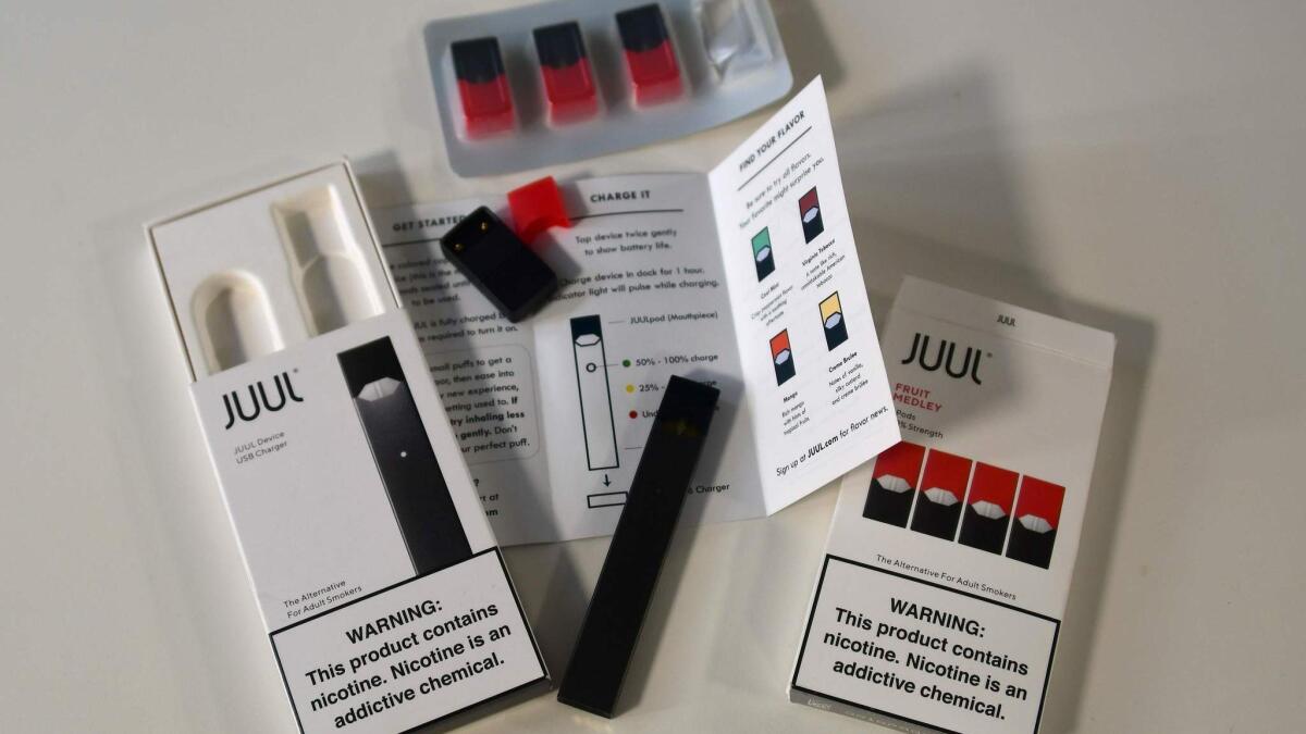 The contents of a Juul e-cigarette box, with the device and cartridges.