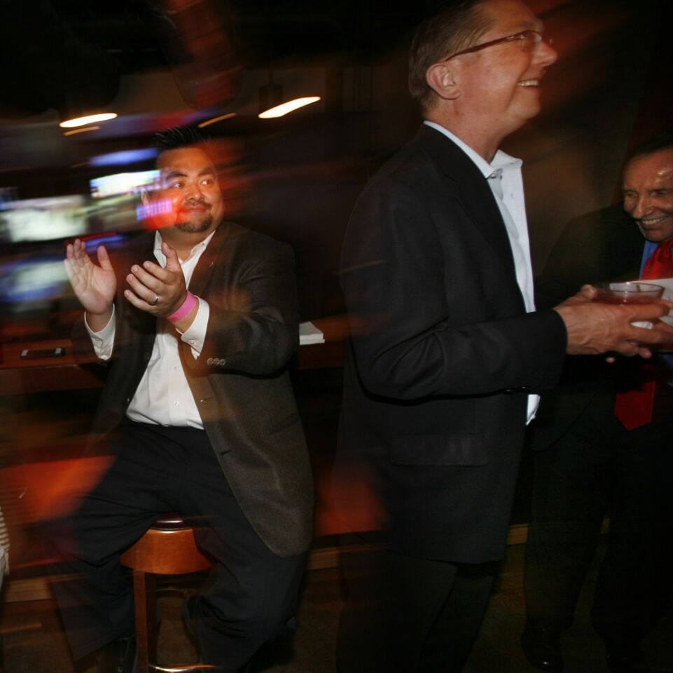 "Yes on D" campaign manager Nam Le, left, claps during an election night gathering at Lucky Strike Lanes in Hollywood as the medical pot measure takes an early lead. John Grant, center, and Rick Icaza, both with the United Food and Commercial Workers International Union, also show their enthusiasm. The measure would limit the number of pot shops in the city to about 130.