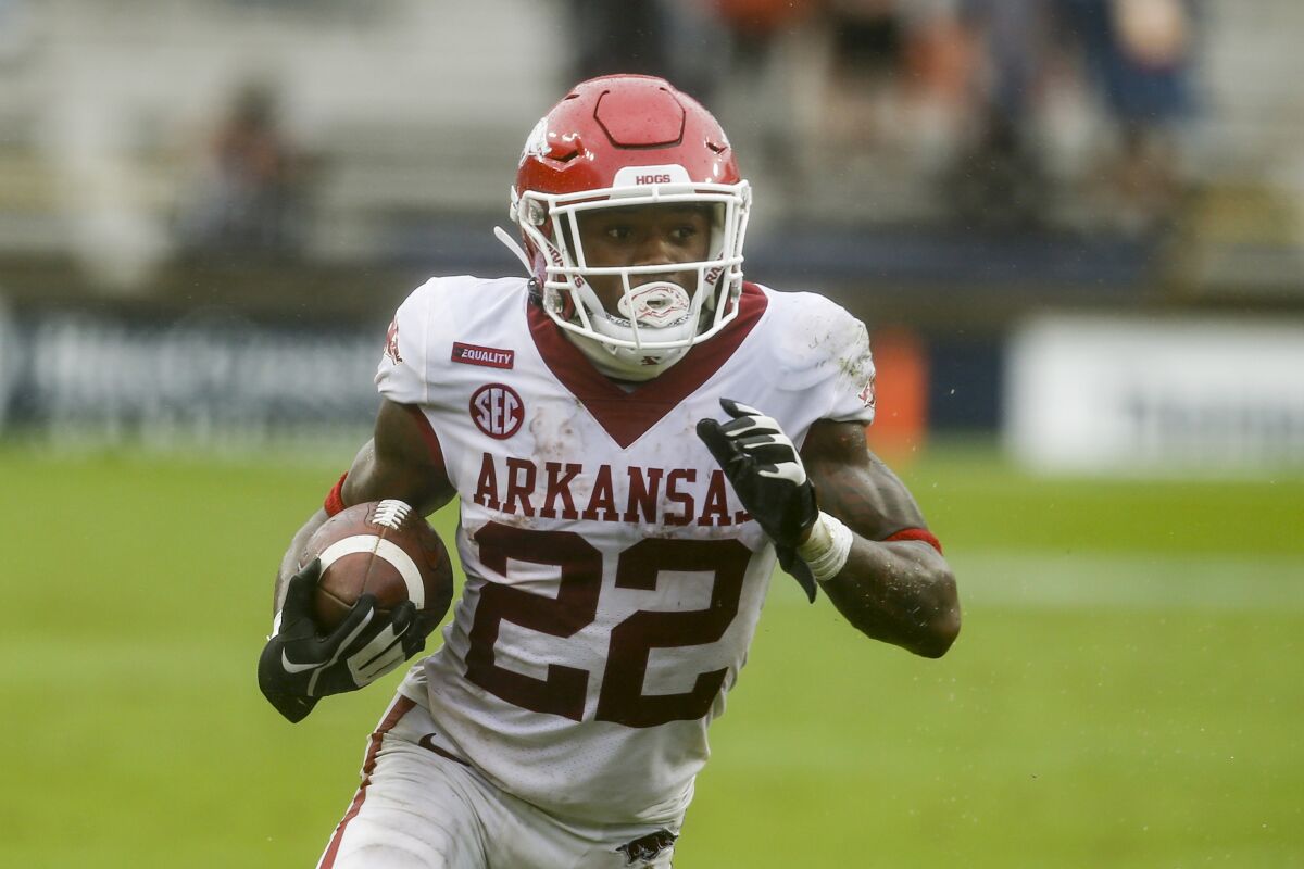 FILE - Arkansas running back Trelon Smith (22) carries the ball against Auburn during the second quarter of an NCAA college football game in Auburn, Ala., in this Saturday, Oct. 10, 2020, file photo. When Rakeem Boyd left the team after a 63-35 loss to Florida, Smith owned the starting job. He hasn’t come to close to giving away the job in the fall after finishing 2020 with 710 yards and five touchdowns on 134 carries. (AP Photo/Butch Dill, File)