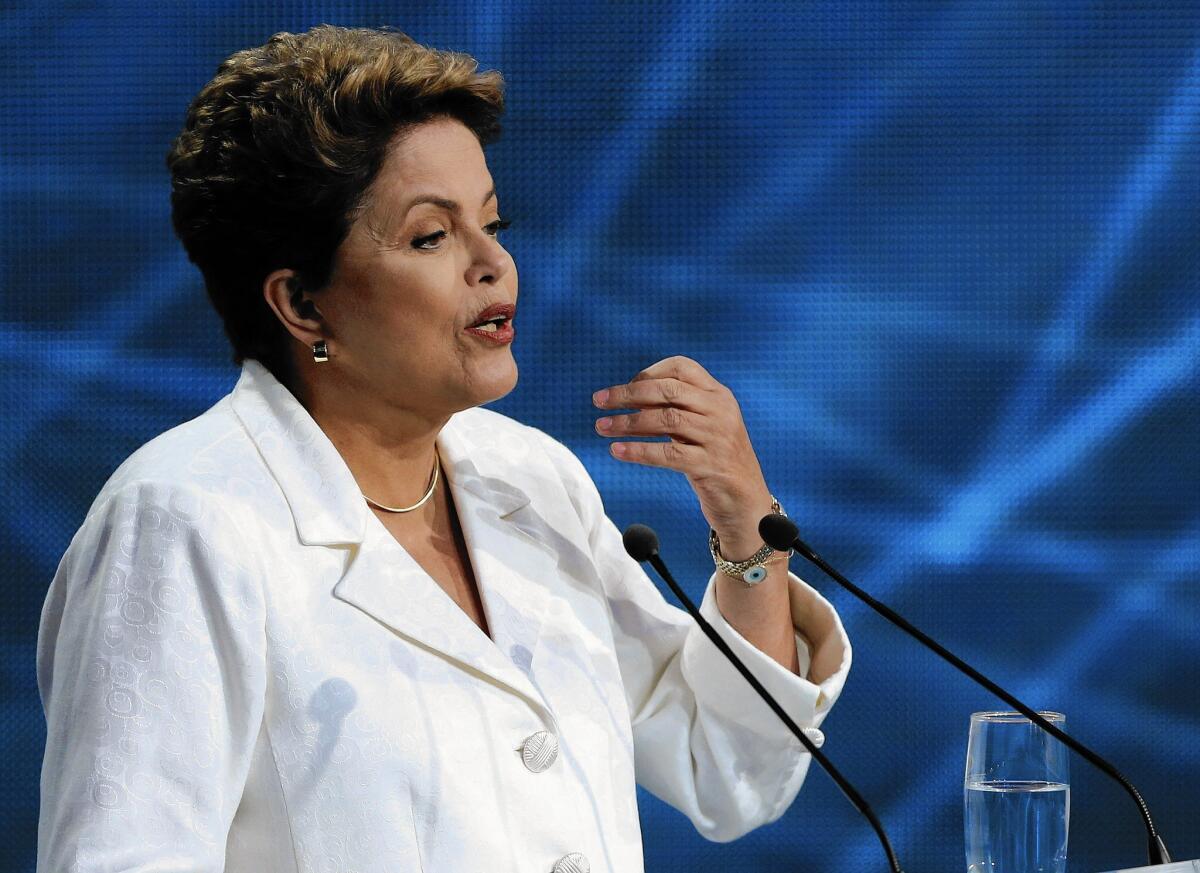 Brazilian President Dilma Rousseff touted her Workers' Party's flagship Bolsa Familia social program, which aids the poor.