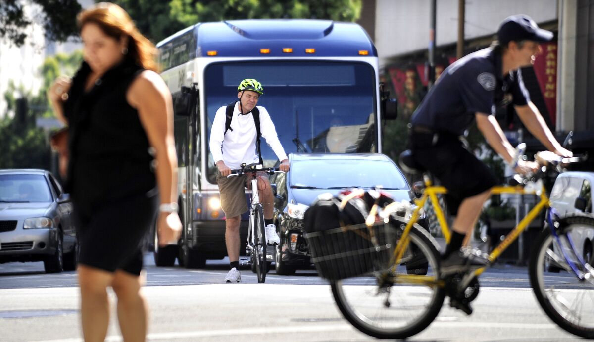 A cyclist uses a bike lane in downtown Los Angeles on Aug. 11. The L.A. City Council recently approved a sweeping transportation plan that calls for the addition of hundreds of miles of new bicycle lanes, bus-only lanes and other road redesigns over the next 20 years.