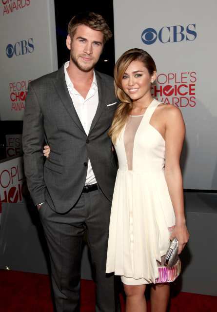 "Hunger Games" actor Liam Hemsworth and singer-actress Miley Cyrus arrive at the People's Choice Awards.