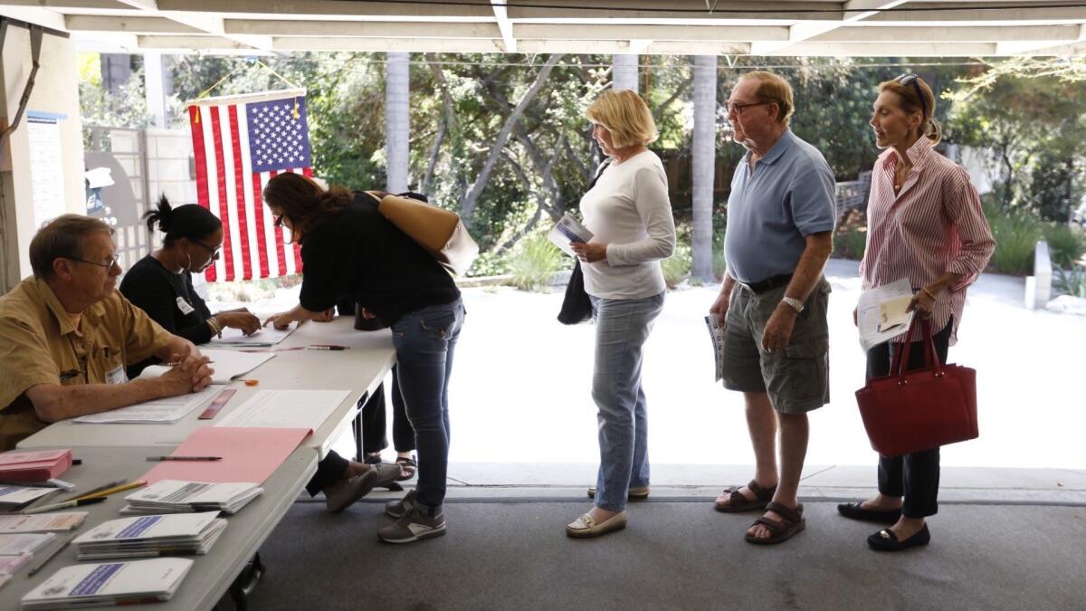 Voters line up to vote in the garage of a home in Sherman Oaks.