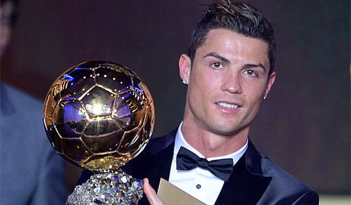 Cristiano Ronaldo poses with the 2013 FIFA Ballon d'Or award for player of the year Monday at a gala in Zurich, Switzerland.