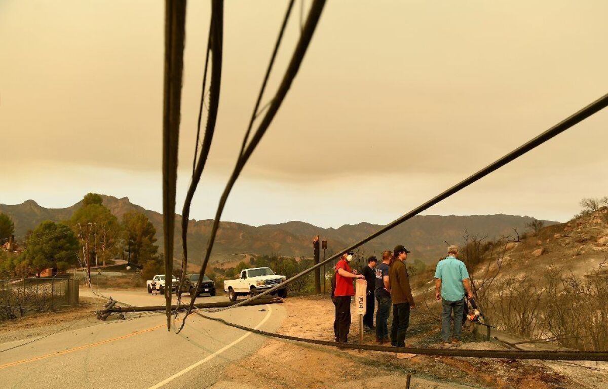 After the Woolsey fire in November, residents try to figure how to navigate around downed power lines on Mullholland Highway in Malibu Lake.