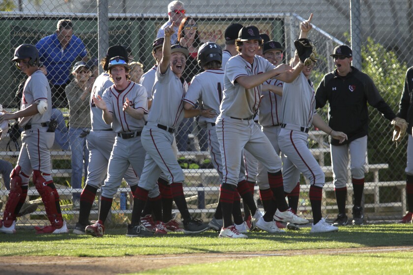 Canyon Crest players celebrate after taking a 1-0 lead in the top of the ninth inning vs. LCC.