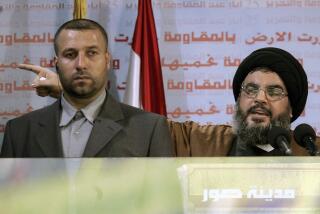 FILE - Hezbollah leader Sayyed Hassan Nasrallah, right, gives an address while accompanied by his bodyguard Yasser Nemr Qranbish, during a rally to mark the sixth anniversary of Israel's withdrawal from southern Lebanon after an 18-year occupation, in the southern port city of Tyre, Lebanon, on May 25, 2006. An Israeli strike in Syria Tuesday July 9, 2024 killed Qranbish, a former personal bodyguard of Hezbollah leader, an official with the Lebanese militant group said. (AP Photo/Hussein Malla, File)