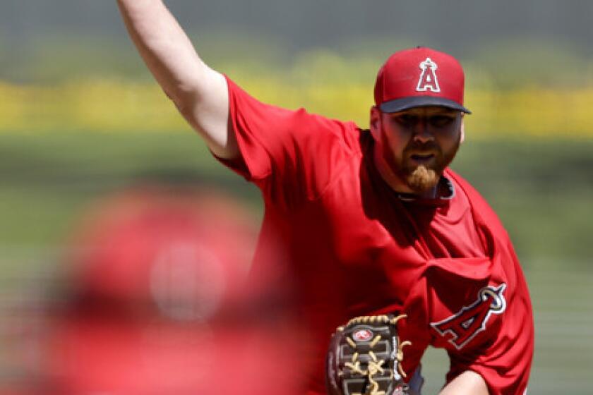 Angels starter Tommy Hanson pitches against the Kansas City Royals in an exhibition game earlier this month.