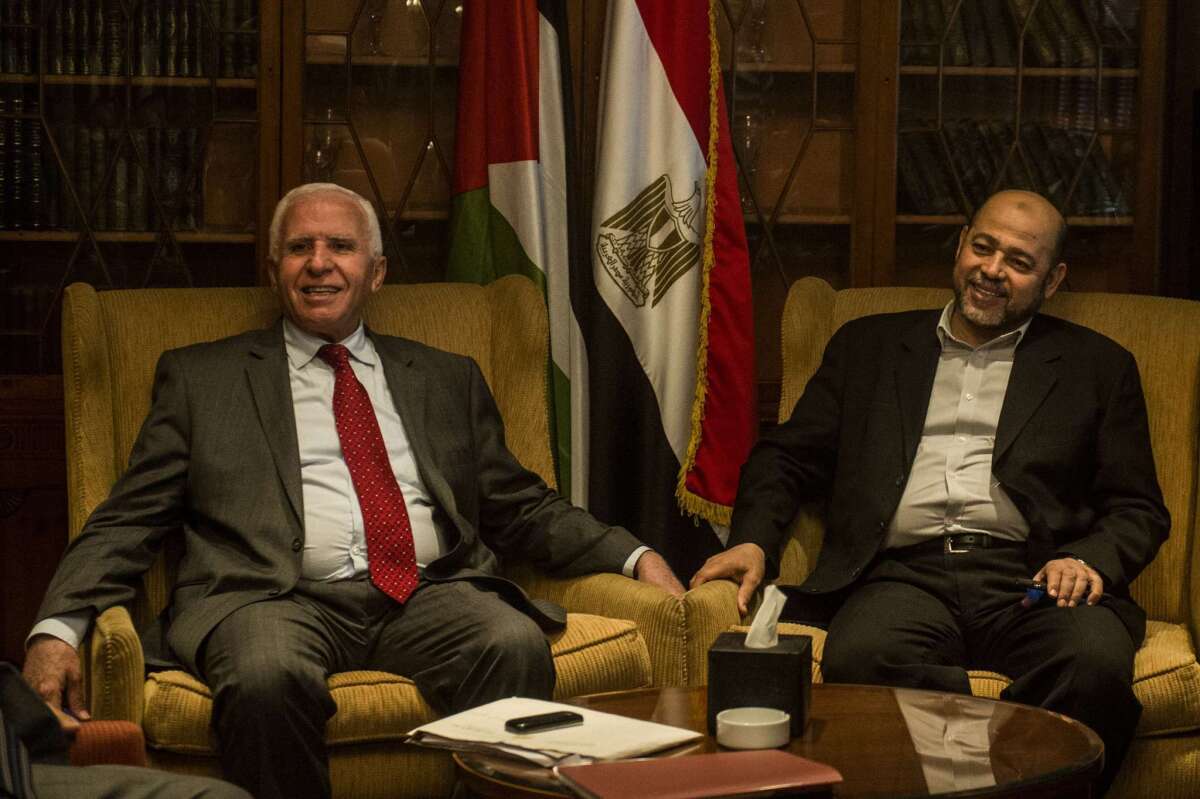 Azzam Ahmad, left, of the Fatah movement and Hamas' exiled deputy leader Moussa Abu Marzouk meet Sept. 24 in a hotel in Cairo.