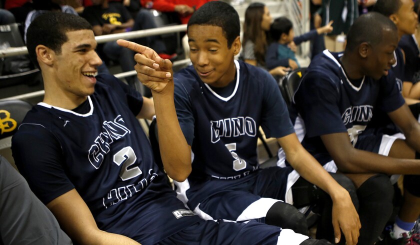 Chino Hills High basketball players Lonzo Ball (2) and his cousin Andre Ball enjoy a light moment during a playoff victory on March 21.