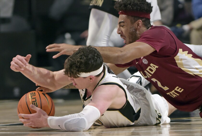 Wake Forest's Jake LaRavia, bottom, and Florida State's Anthony Polite battle for a loose ball in the first half of an NCAA college basketball game, Tuesday, Jan. 4, 2022 at Joel Coliseum in Winston-Salem, N.C. (Walt Unks/The Winston-Salem Journal via AP)