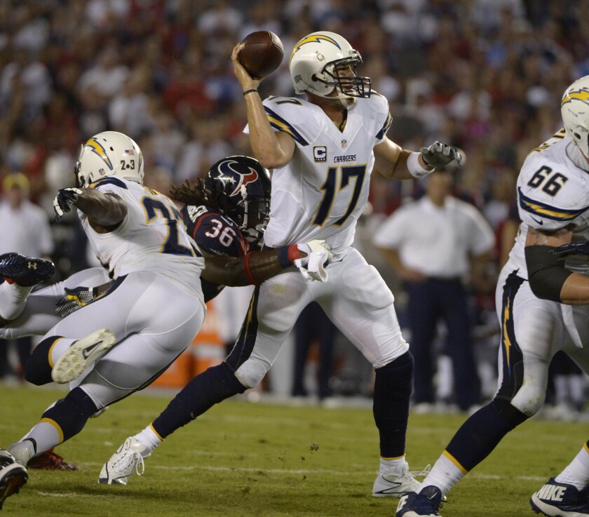 Chargers quarterback Philip Rivers throws a pass under pressure in a game against the Houston Texans in 2013 at Qualcomm Stadium.