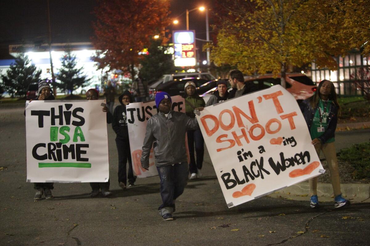 Protesters this month held signs during a rally in Dearborn Heights, Mich., to protest the shooting death of Renisha McBride.