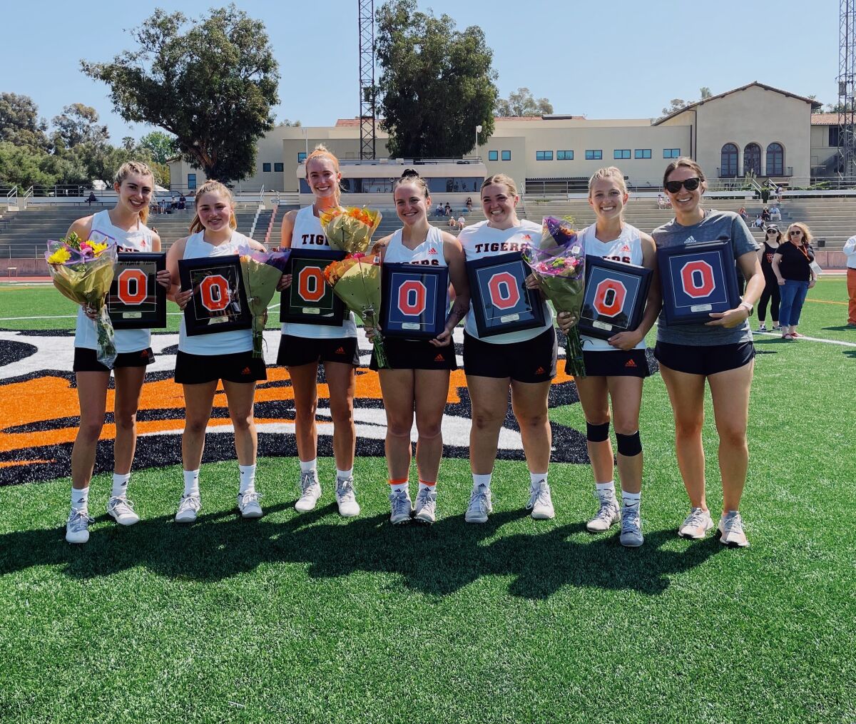 The six seniors of the Occidental women's lacrosse team pose for a photo with coach Hannah Khin before a game in April 2022.