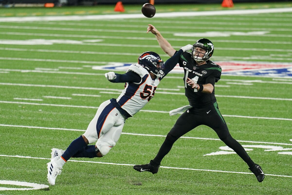 Denver Broncos outside linebacker Bradley Chubb (55) pressures New York Jets quarterback Sam Darnold (14) during the first half of an NFL football game Thursday, Oct. 1, 2020, in East Rutherford, N.J. (AP Photo/John Minchillo)