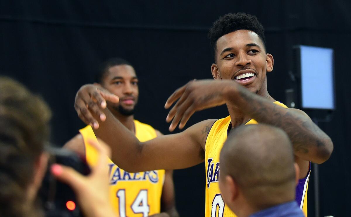 Nick Young has some fun during Lakers media day Sept. 29 in El Segundo. He returns to play against the Atlanta Hawks on Tuesday night after almost seven weeks out because of a torn ligament in his right thumb.