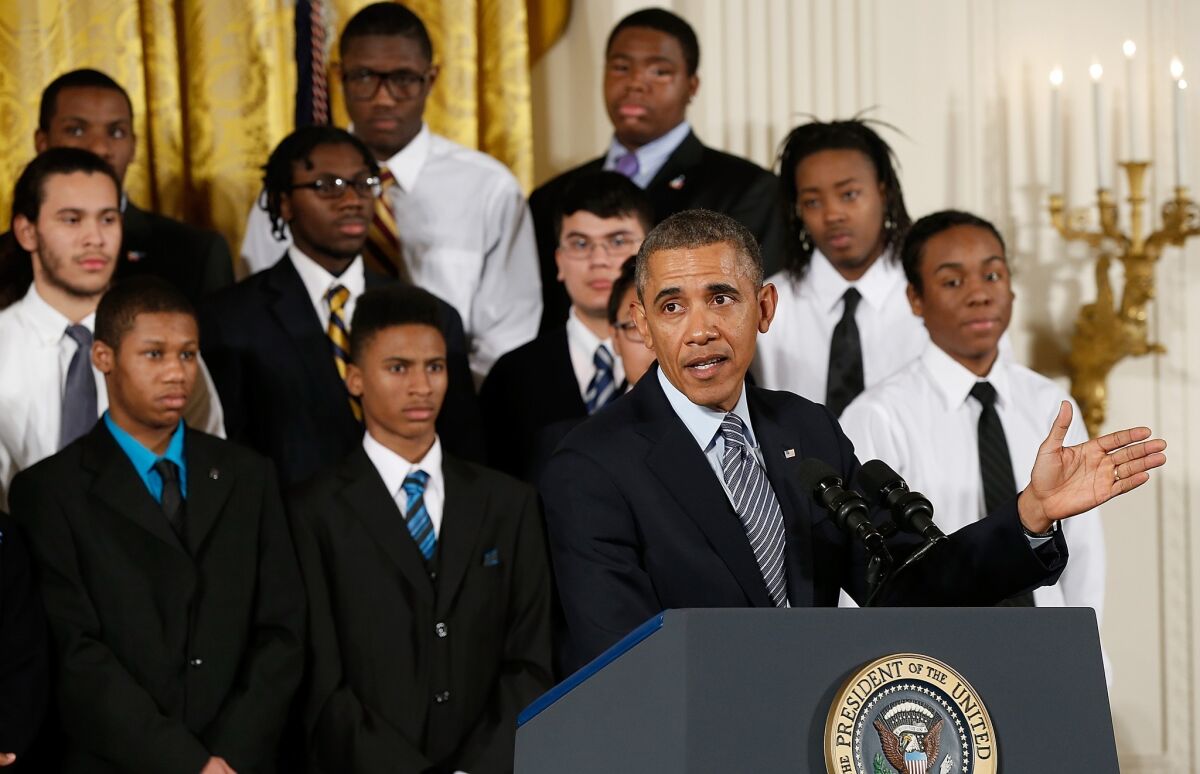 President Obama speaks as young men who participate in the Becoming A Man program in Chicago watch during a Feb. 27 event in the East Room of the White House. Obama signed an executive memorandum following remarks on the My Brother's Keeper initiative.