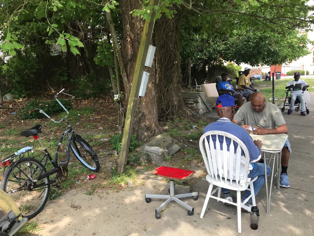 In the Uptown neighborhood of New Orleans last weekend, people who knew some of those with COVID-19 who had died gathered as usual under a community tree.