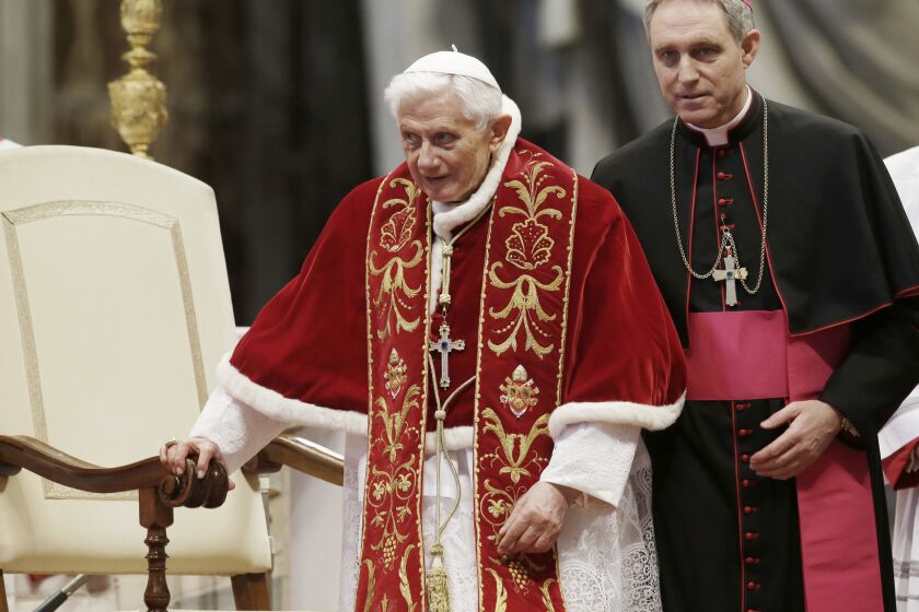 ARCHIVO - El papa Benedicto XVI, acompañado de su secretario personal, el arzobispo Georg Gaenswein, durante la celebración de una misa por el 900 aniversario de los Caballeros de la Orden de Malta, en la basílica de San Pedro, en el Vaticano, el 9 de febrero de 2013. (AP Foto/Gregorio Borgia, Archivo)