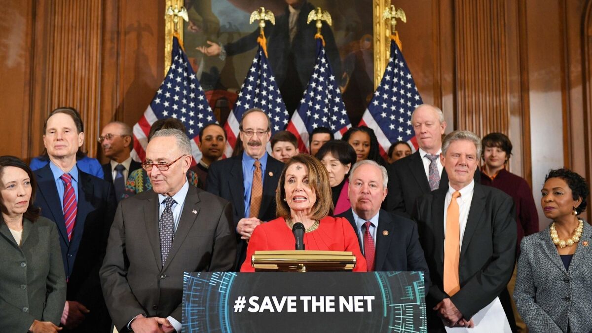 House Speaker Nancy Pelosi, alongside Senate Minority Leader Chuck Schumer (second from left), announces net neutrality legislation at the Capitol on March 6.