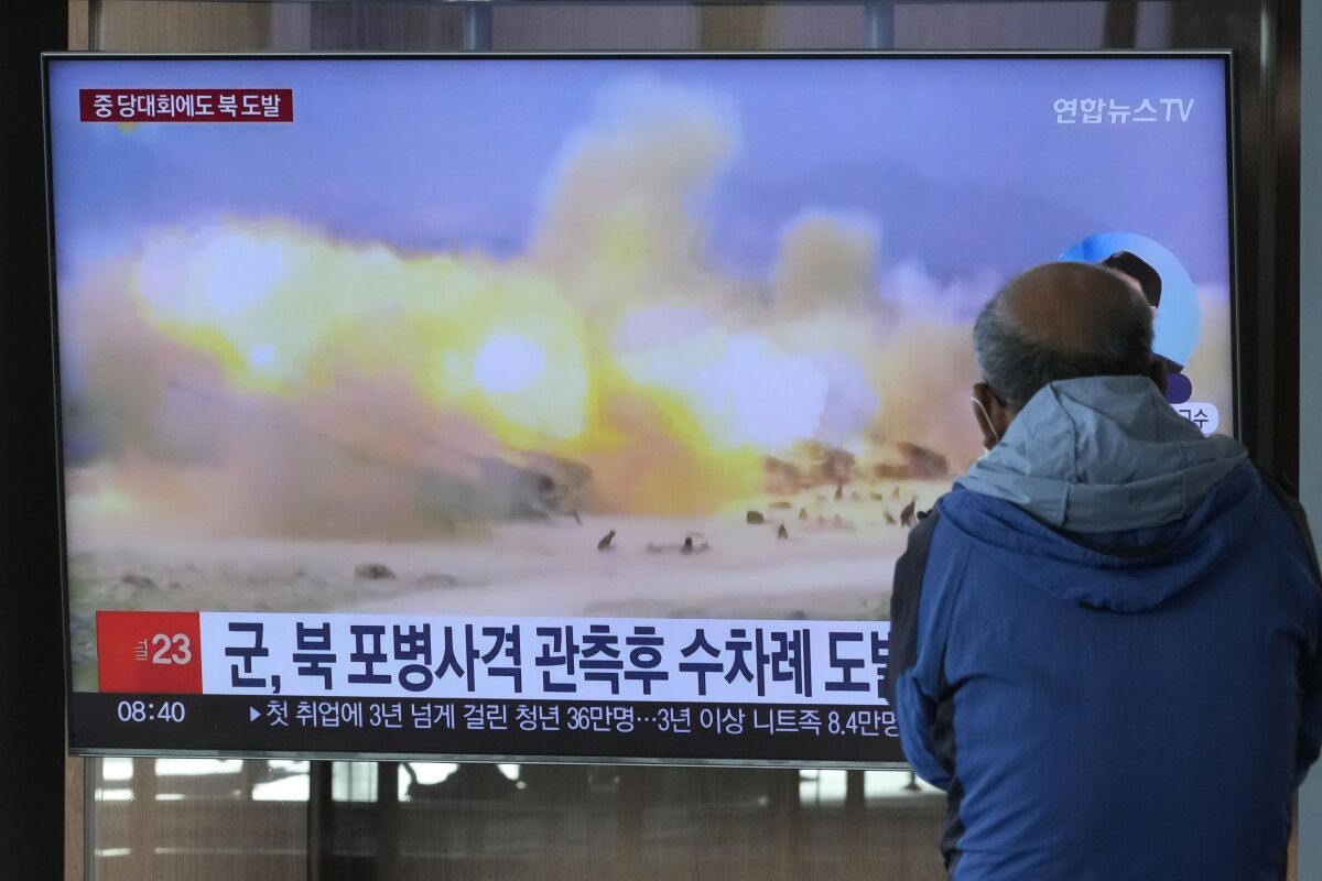 FILE - A TV screen shows a file image of North Korea's military exercise during a news program at the Seoul Railway Station in Seoul, South Korea, Wednesday, Oct. 19, 2022. South Korea’s military says North Korea has fired around 130 suspected artillery rounds Monday, Dec. 5, 2022, in waters near the rivals’ western and eastern sea borders in another display of belligerence. (AP Photo/Ahn Young-joon, File)