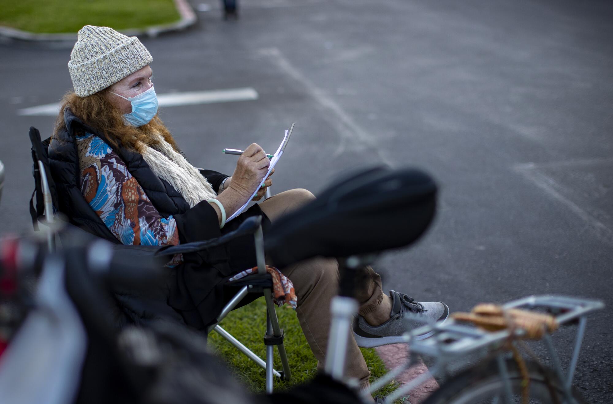 Nancy Wood spends an afternoon making street drawings of passersby at a strip mall near the Fountain Valley park