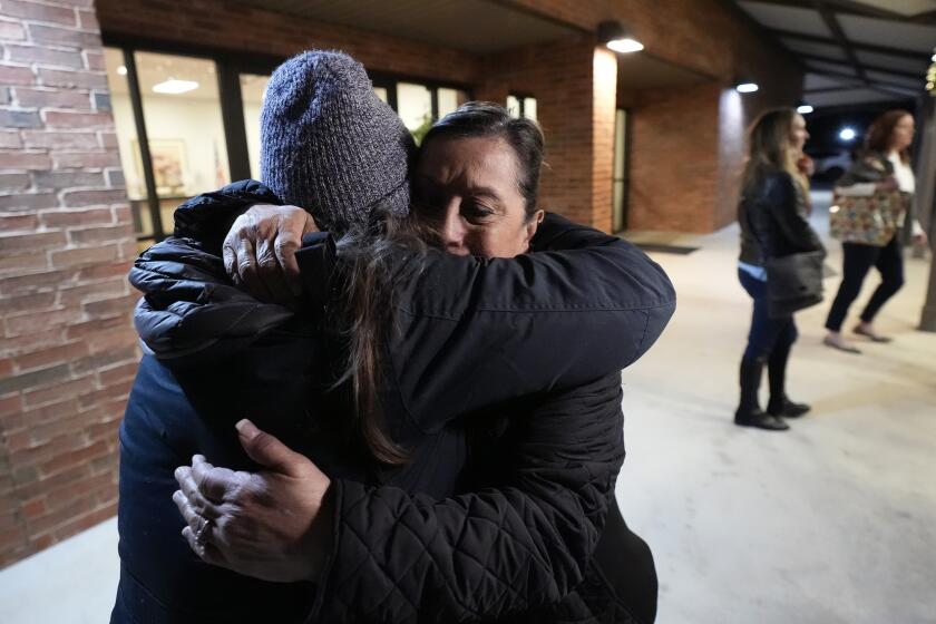 Dora Mendoza, right, is hugged by a friend as she leaves a meeting where Attorney General Merrick Garland shared a report on the findings of an investigation into the 2022 school shooting at Robb Elementary School, Wednesday, Jan. 17, 2024, in Uvalde, Texas. Mendoza is the grandmother of 10-year-old Amerie Jo Garza who was killed in the shooting. (AP Photo/Eric Gay)
