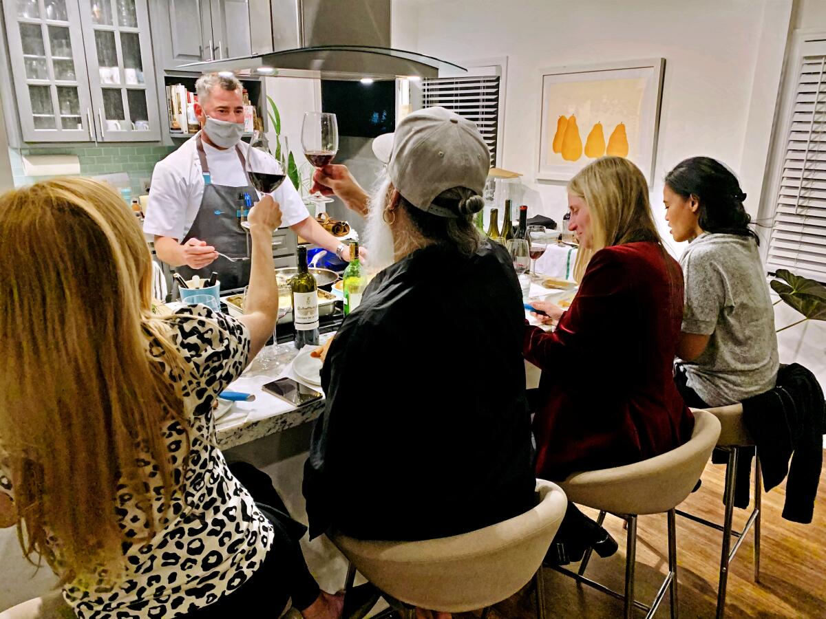 Kevin Meehan, chef-owner of Kali restaurant, cooks a meal for a small gathering at a customer's home in December.