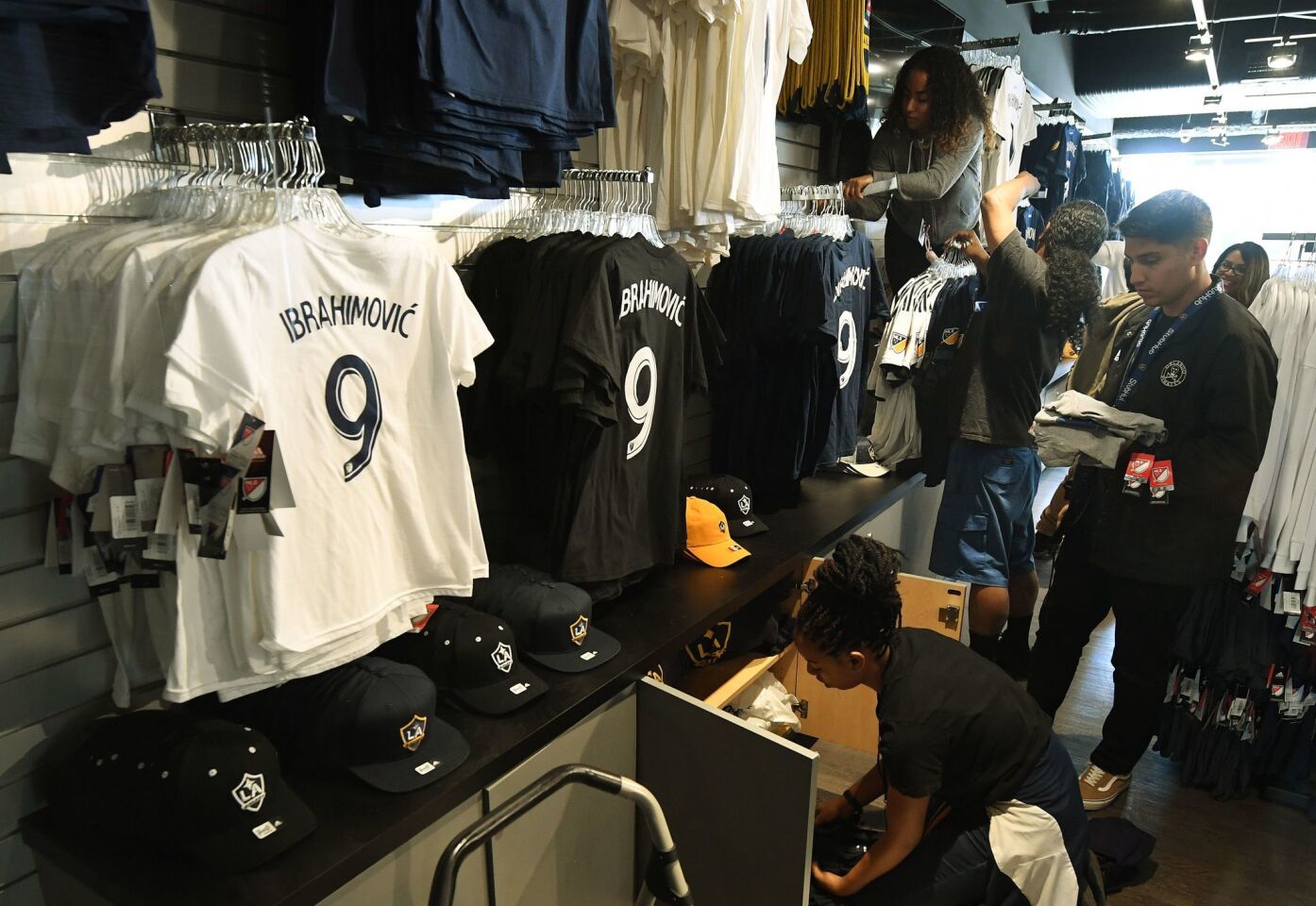 Store staff prepare for sales of the new jersey for football star Zlatan Ibrahimovic after his first training session with his new club LA Galaxy in Los Angeles, California, on March 30, 2018. The 36-year-old Swedish striker's move to MLS from Manchester United was confirmed last week, with Ibrahimovic swiftly vowing to reignite the Galaxy's fortunes after they finished bottom of the league last season. / AFP PHOTO / Mark RALSTONMARK RALSTON/AFP/Getty Images ** OUTS - ELSENT, FPG, CM - OUTS * NM, PH, VA if sourced by CT, LA or MoD **