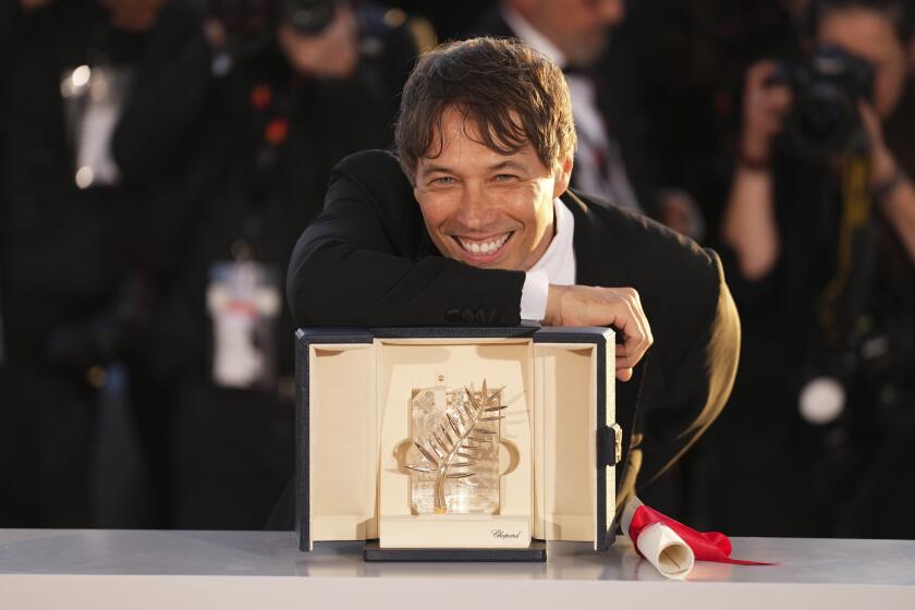 A smiling director poses with an award.