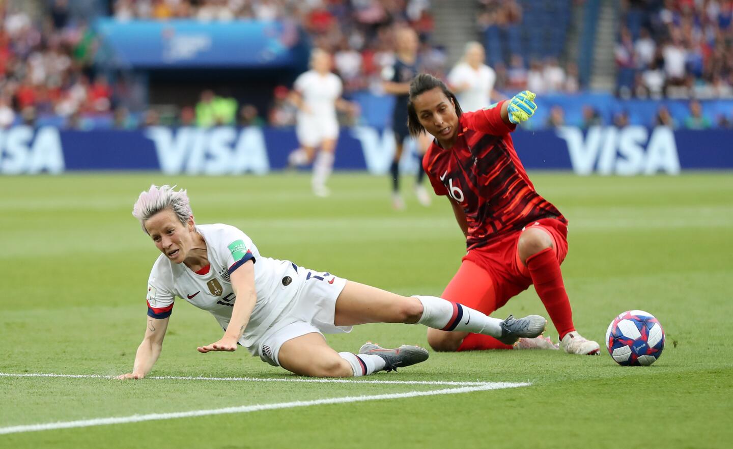 U.S. forward Megan Rapinoe challenges France goalkeeper Sarah Bouhaddi for the ball during a Women's World Cup quarterfinal match in Paris on June 28.