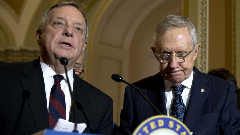 Senate Minority Leader Harry Reid of Nev. listens at right, as Senate Minority Whip Richard Durbin of Ill. speaks during a news conference on Capitol Hill, where Democrats blocked the sanctuary city bill.
