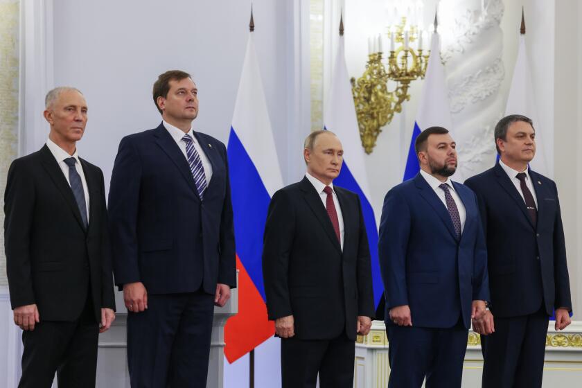 From left, Moscow-appointed head of Kherson Region Vladimir Saldo, Moscow-appointed head of Zaporizhzhia region Yevgeny Balitsky, Russian President Vladimir Putin, center, Denis Pushilin, the leader of the Donetsk People's Republic and Leonid Pasechnik, leader of self-proclaimed Luhansk People's Republic stand during a ceremony to sign the treaties for four regions of Ukraine to join Russia, at the Kremlin in Moscow, Friday, Sept. 30, 2022. The signing of the treaties making the four regions part of Russia follows the completion of the Kremlin-orchestrated "referendums." (Mikhail Metzel, Sputnik, Kremlin Pool Photo via AP)