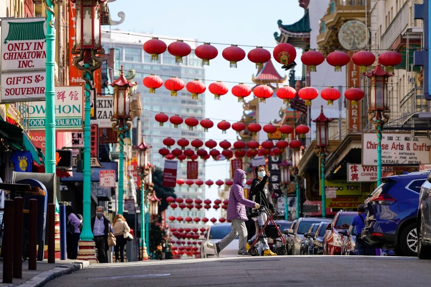 People cross Grant Avenue in Chinatown in San Francisco