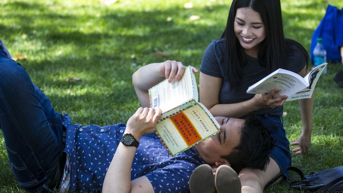 Jason Ham and Baily Pham enjoy reading together during the annual Los Angeles Times Festival of Books at USC on April 22, 2018.