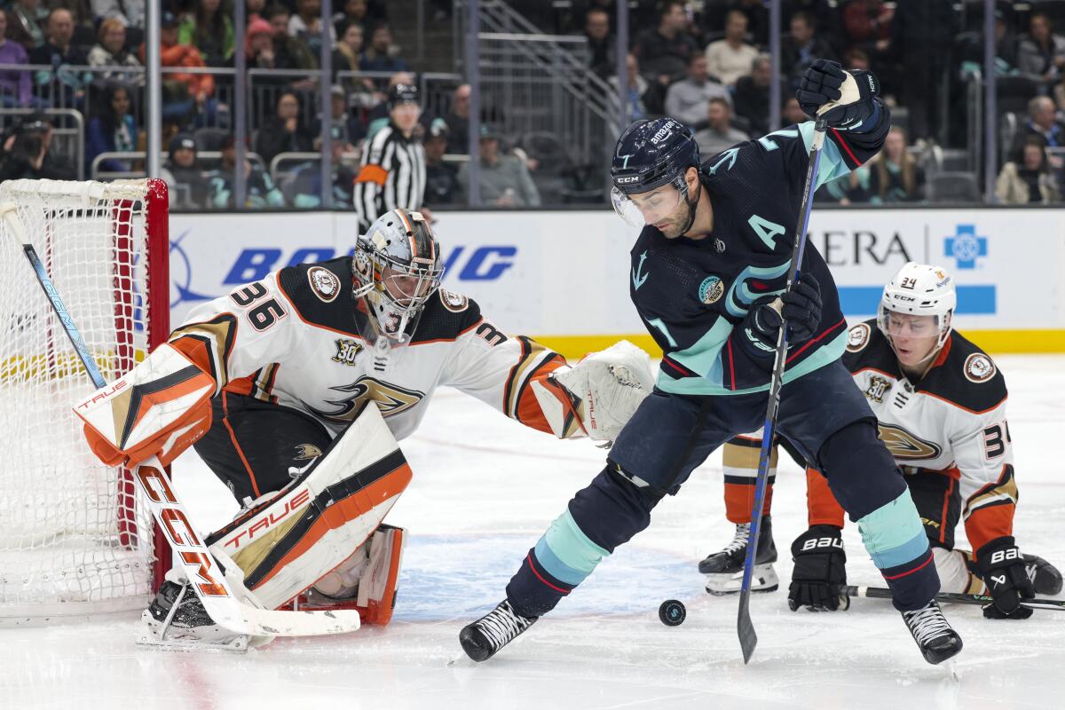 Seattle's Jordan Eberle tries to score on Ducks goalie John Gibson as Pavel Mintyukov watches in the third period.