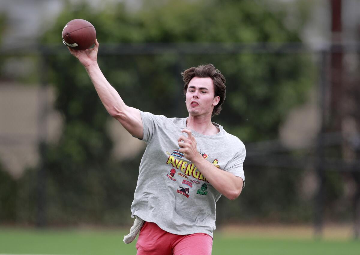 Incoming USC freshman quarterback J.T. Daniels passes to his teammate, wide receiver Amon-Ra St. Brown at Golden West College on May 30.