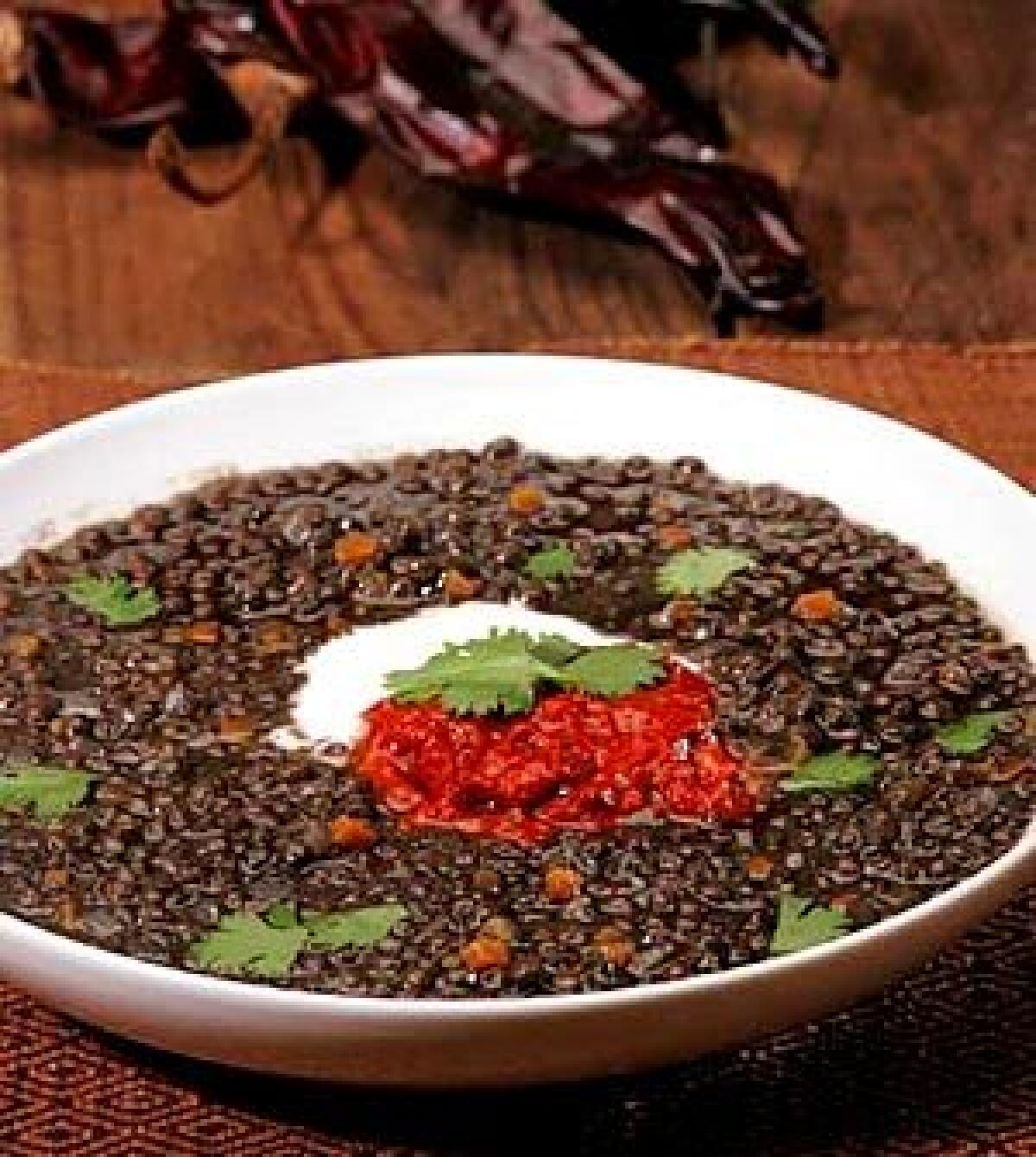 Swirled with yogurt into beluga lentil soup, a tomato-pepper harissa adds spice and depth.