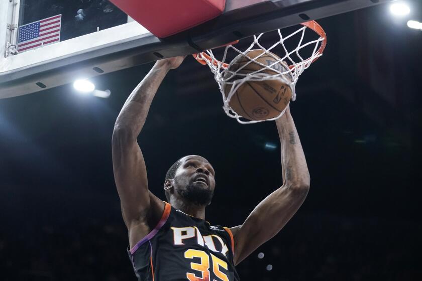 Phoenix Suns forward Kevin Durant dunks against the Cleveland Cavaliers during the first half of an NBA basketball game in Phoenix, Wednesday, April. 3, 2024. (AP Photo/Darryl Webb)