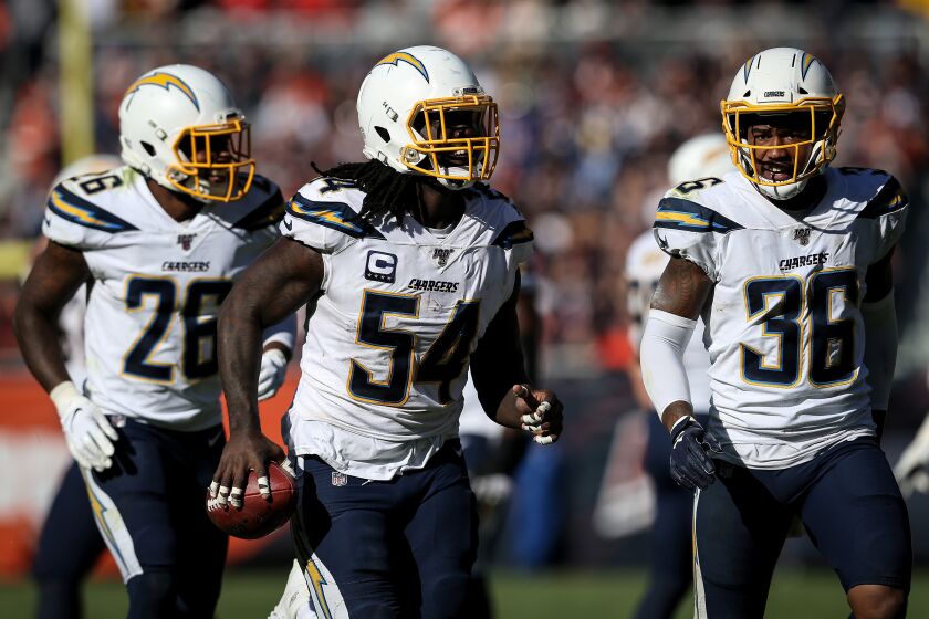 CHICAGO, ILLINOIS - OCTOBER 27: Melvin Ingram III #54 of the Los Angeles Chargers celebrates after recovering a fumble in the fourth quarter against the Chicago Bears at Soldier Field on October 27, 2019 in Chicago, Illinois. (Photo by Dylan Buell/Getty Images)