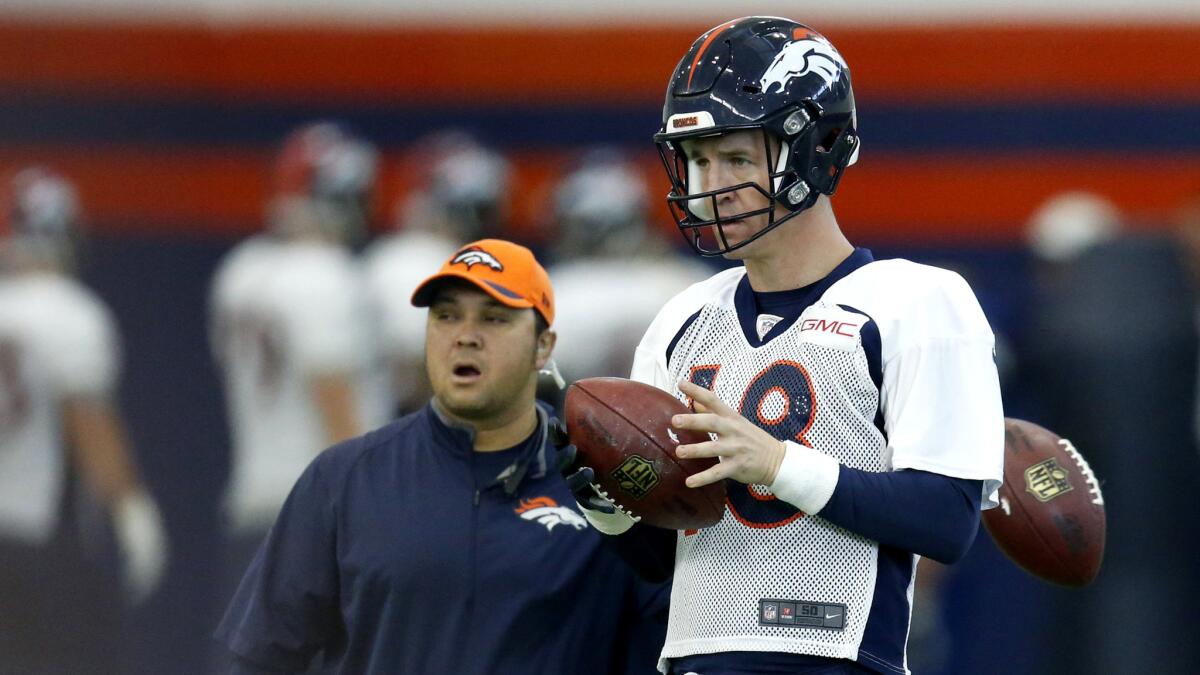 Broncos quarterback Peyton Manning warms up for practice Wednesday.